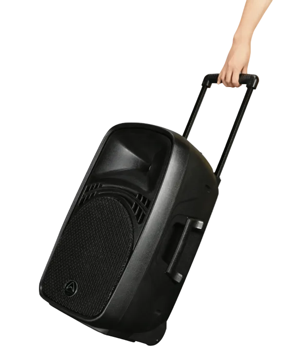 Black portable speaker with wheels held by a hand on a light gray background
